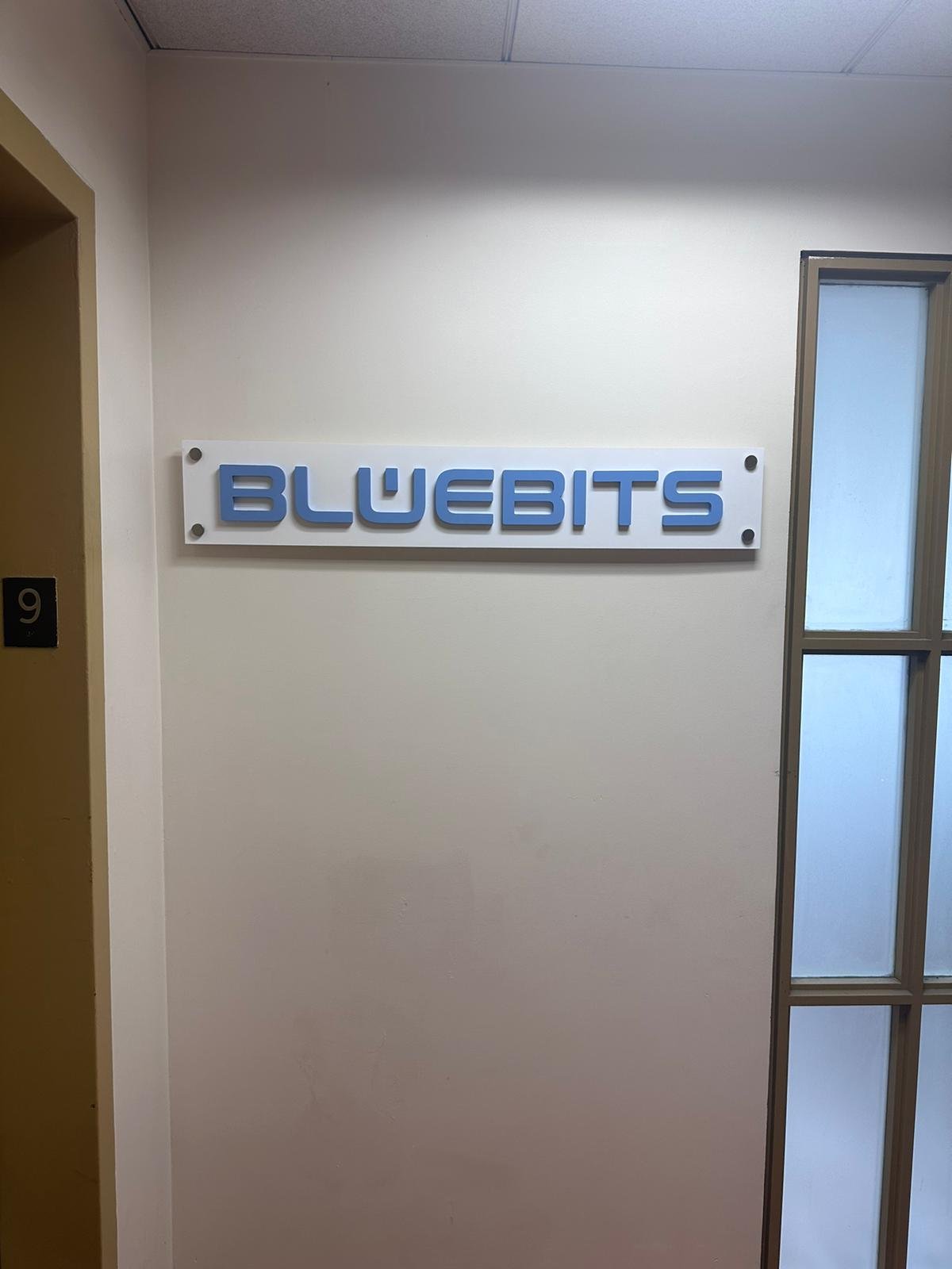 A sign hanging on the wall of a room.