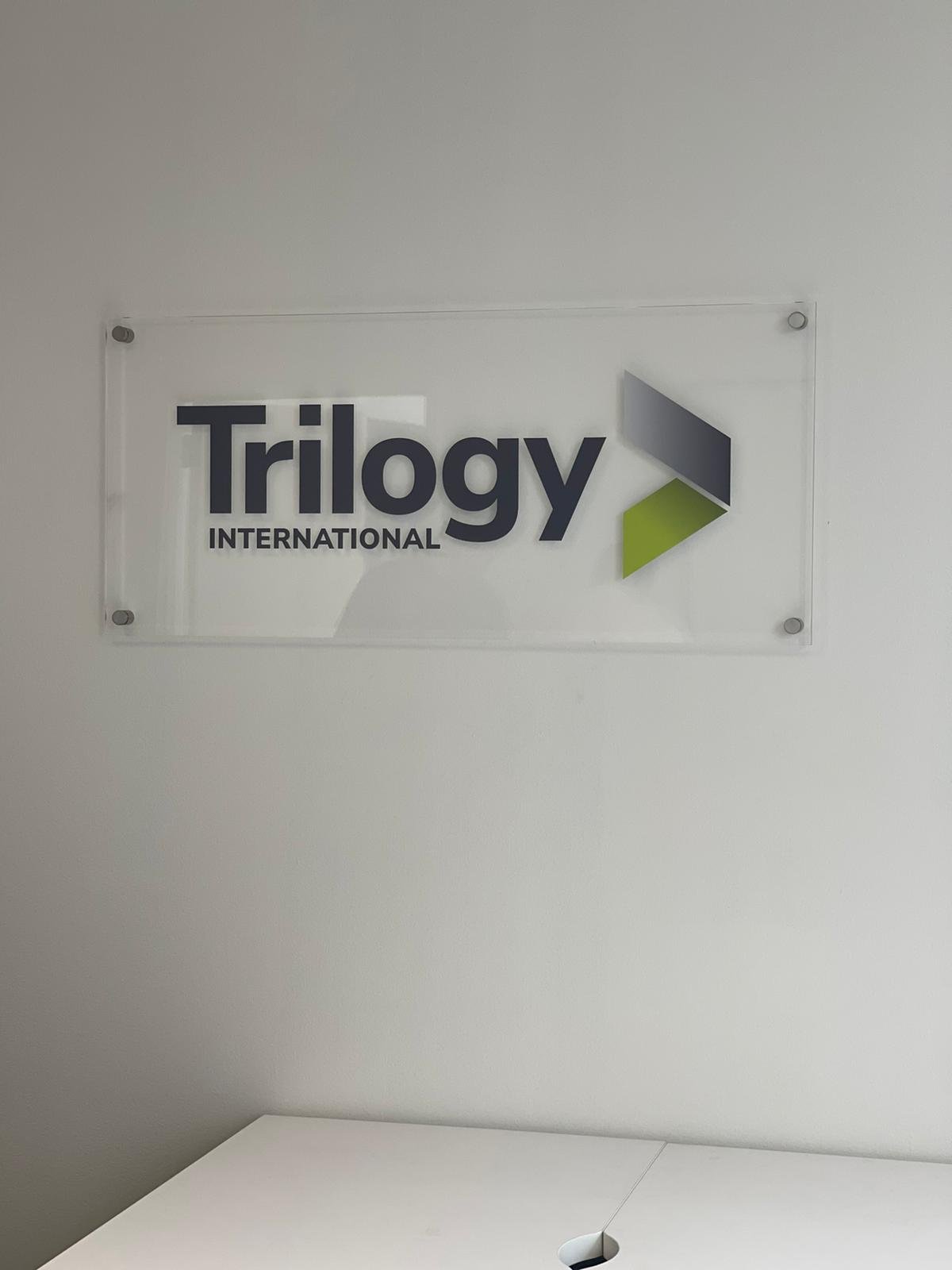 A sign that says trilogy international