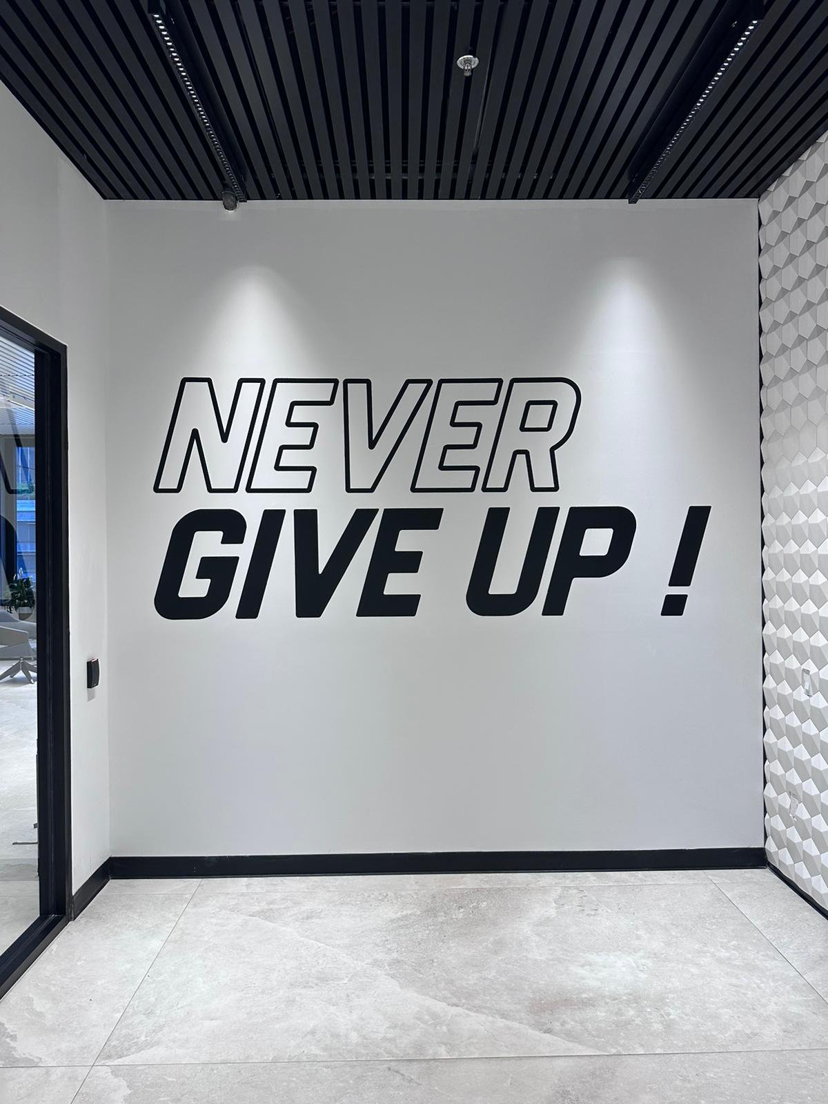 A wall with the words never give up on it
