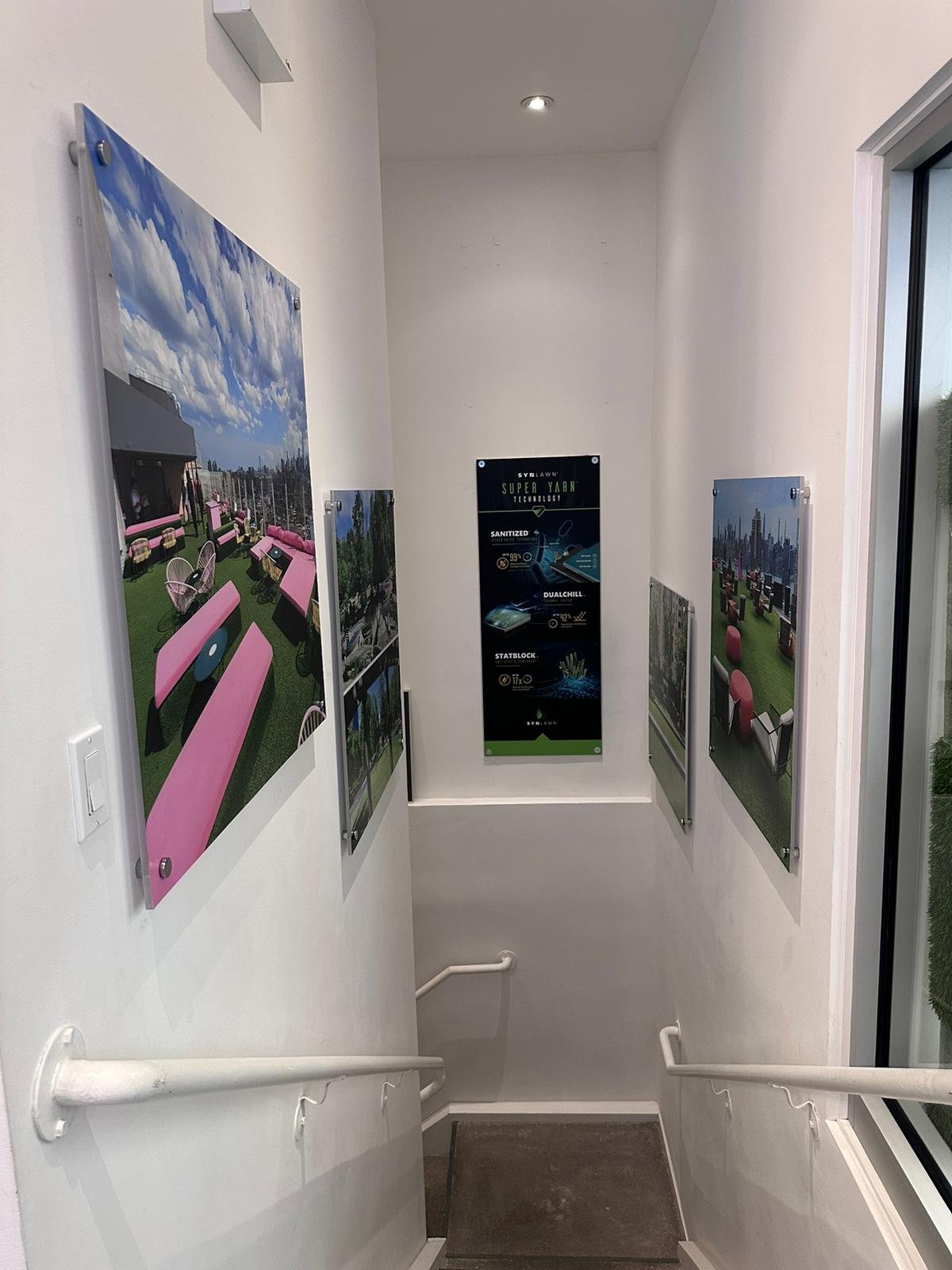A hallway with several paintings on the wall.