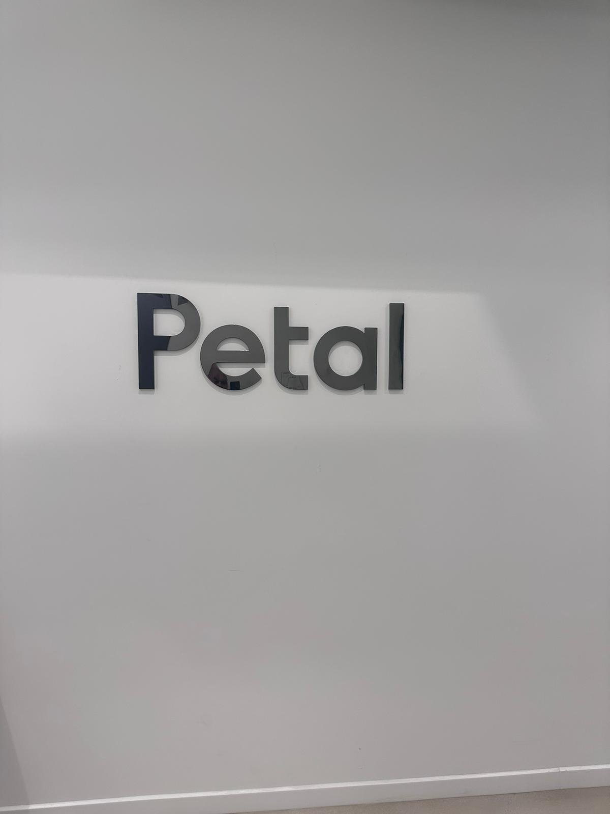 A close up of the word petal on a wall
