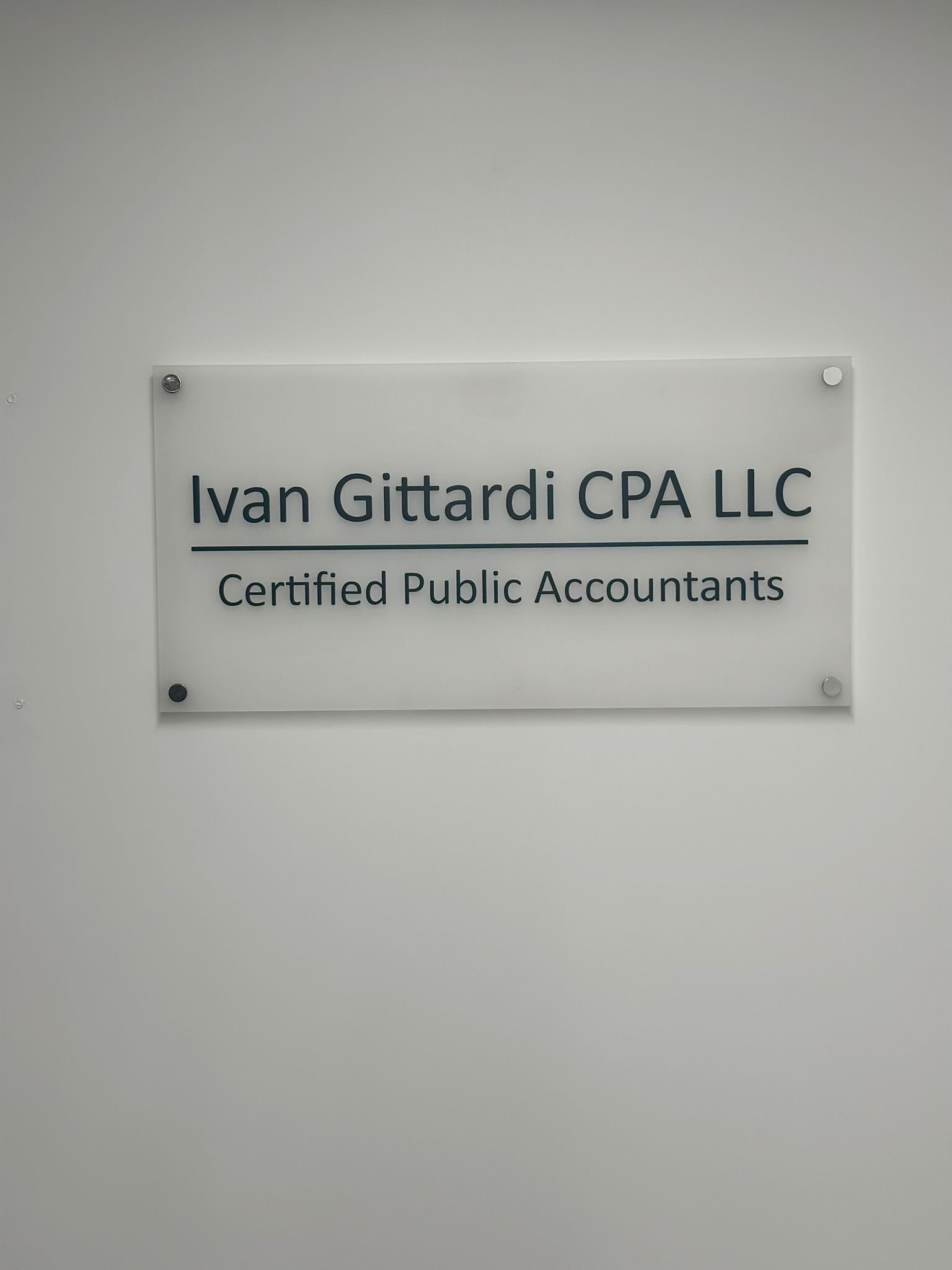 A sign hanging on the wall of an office.
