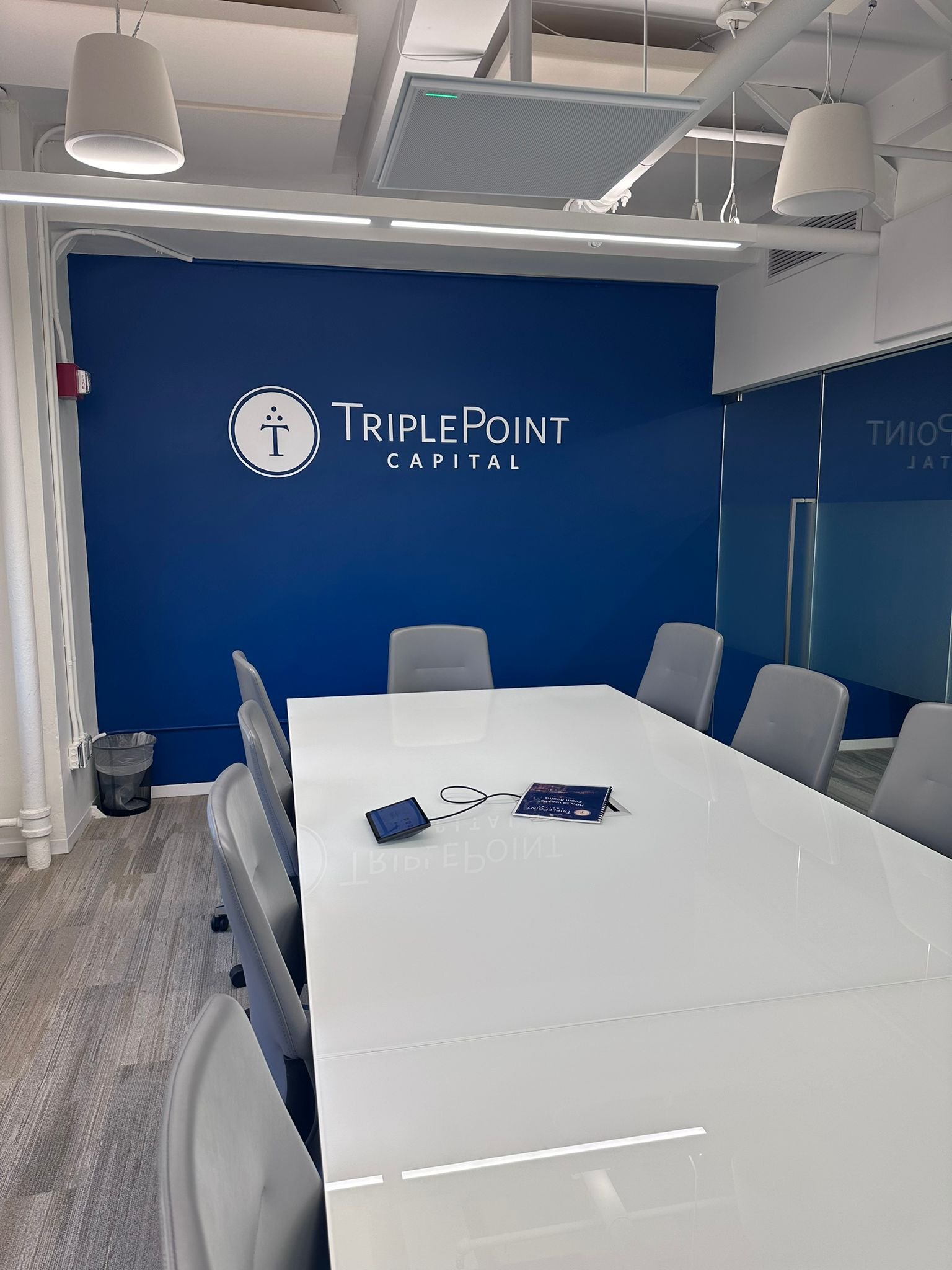 A conference room with six chairs and a table.