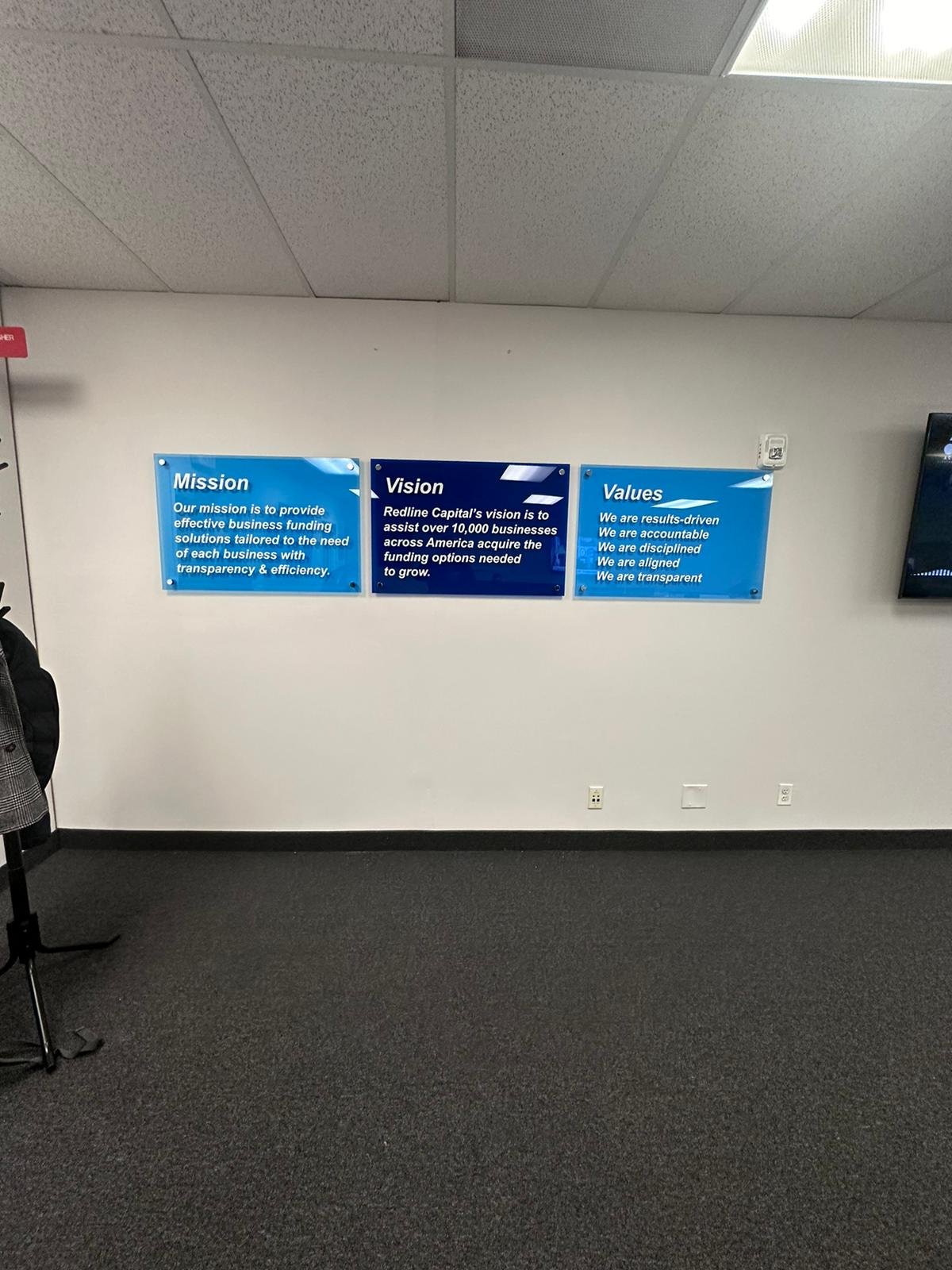 A person standing in front of some blue signs.