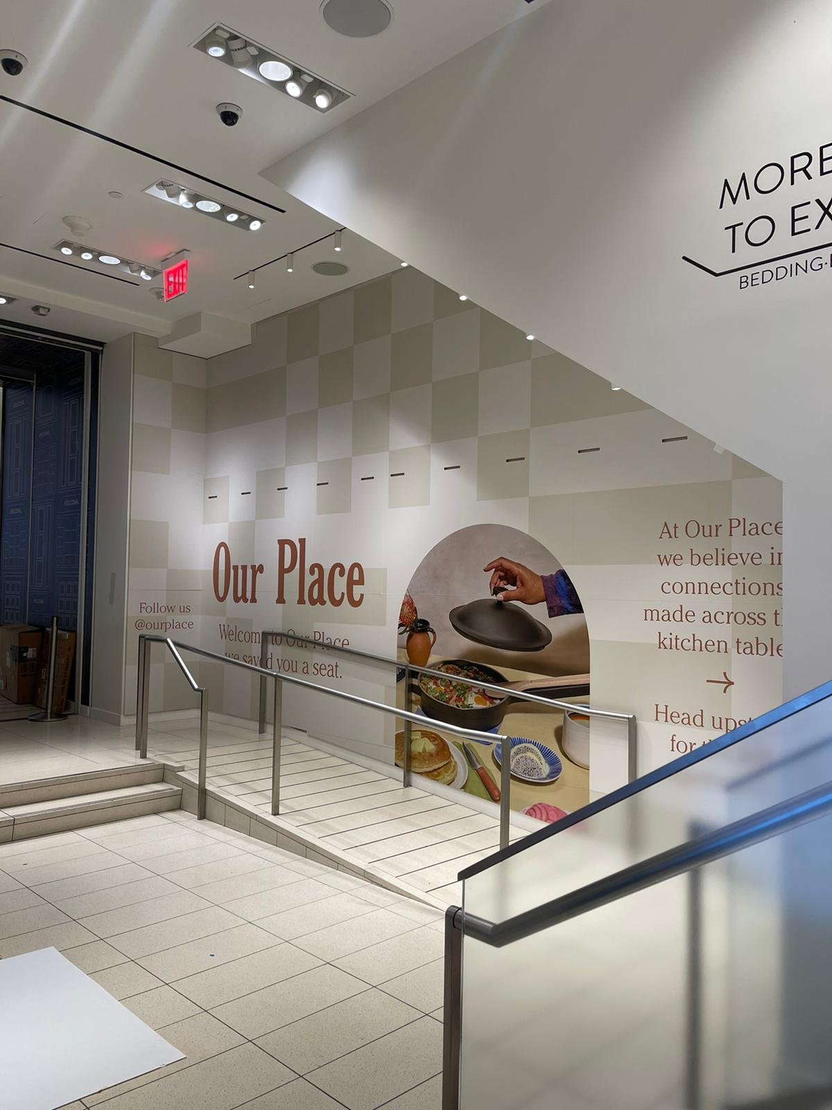 A white wall with a sign on it that says " our place ".