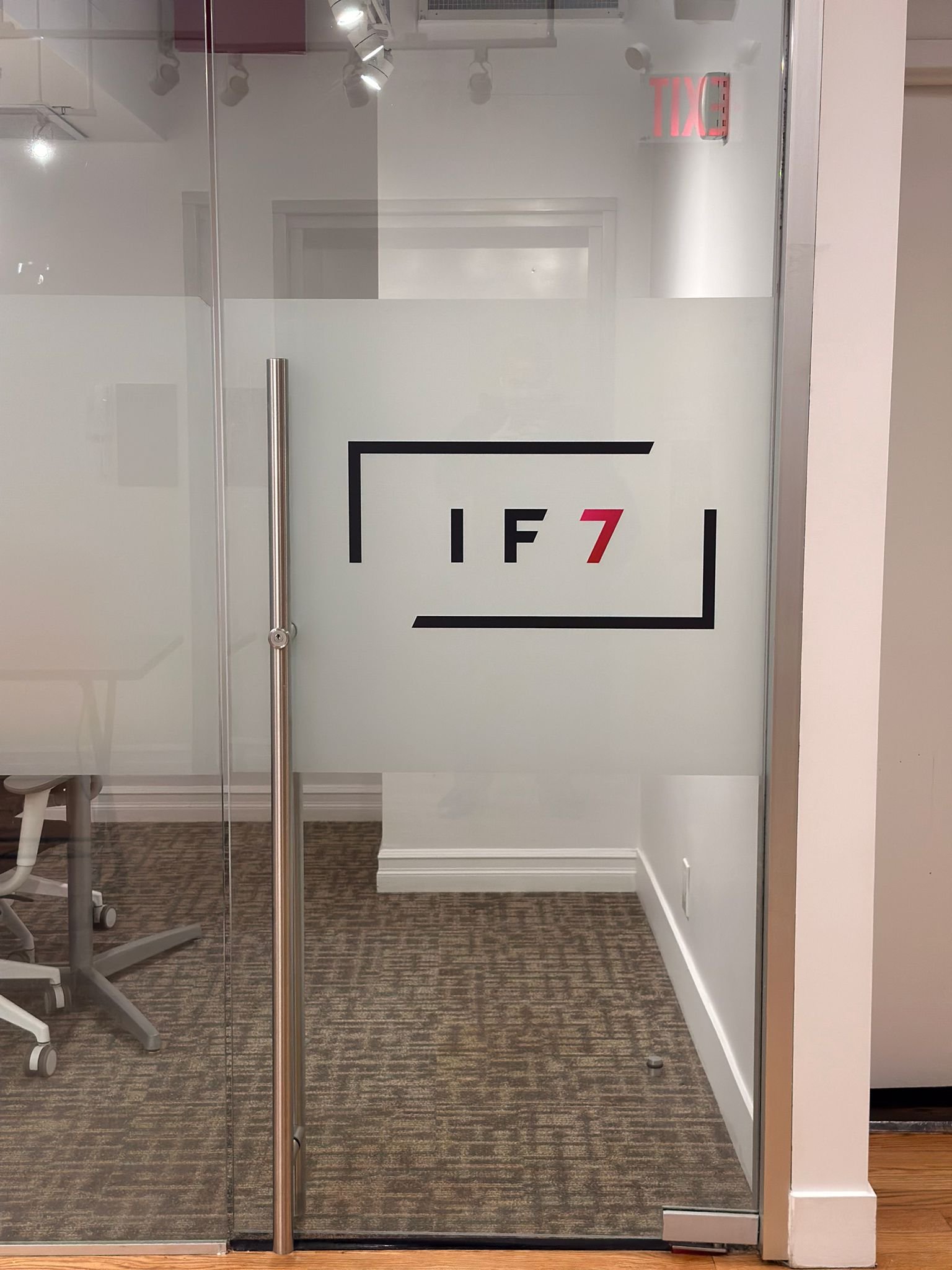 A glass door with the words if 7 written on it.