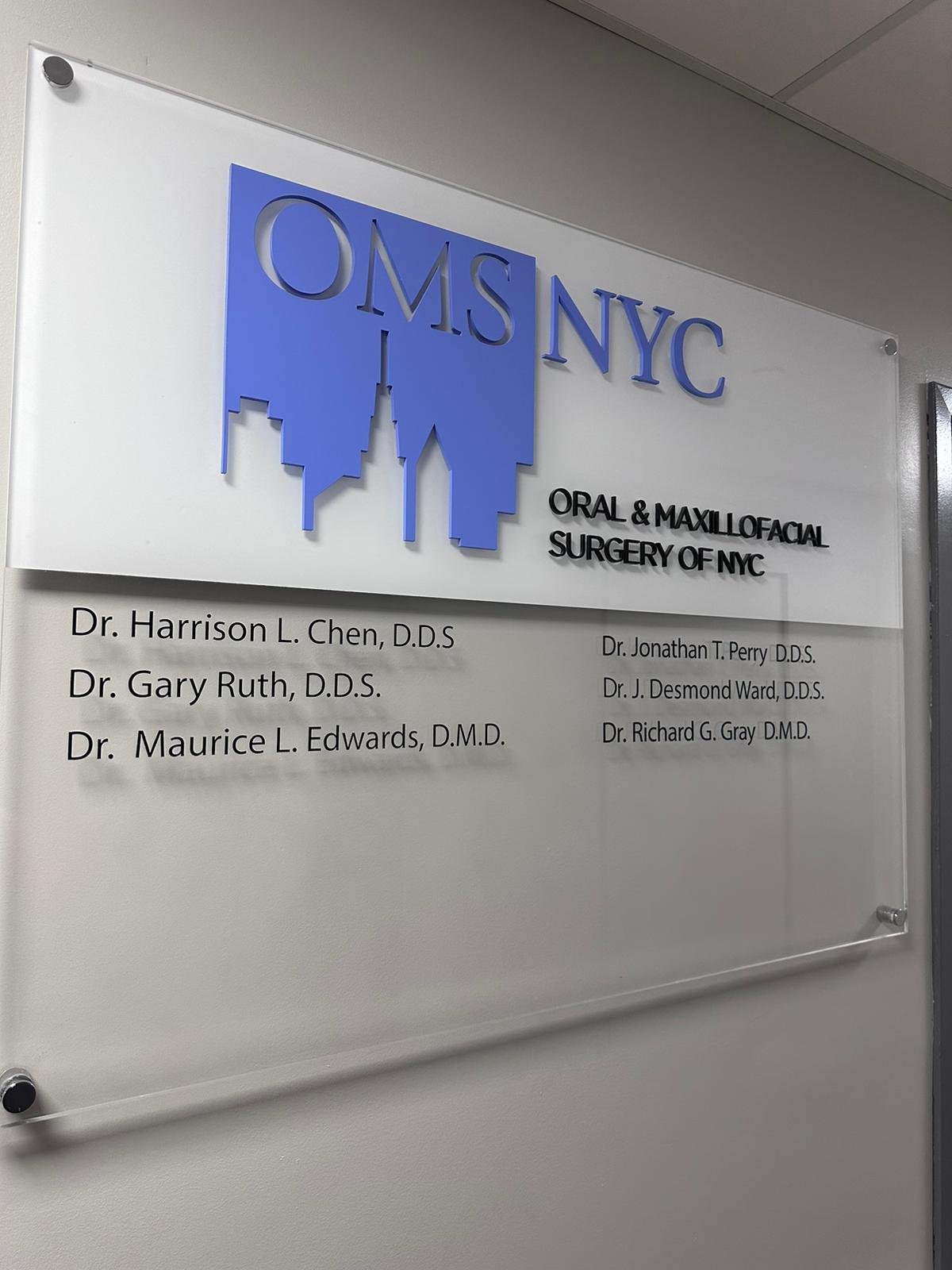 A sign in front of the entrance to an office building.