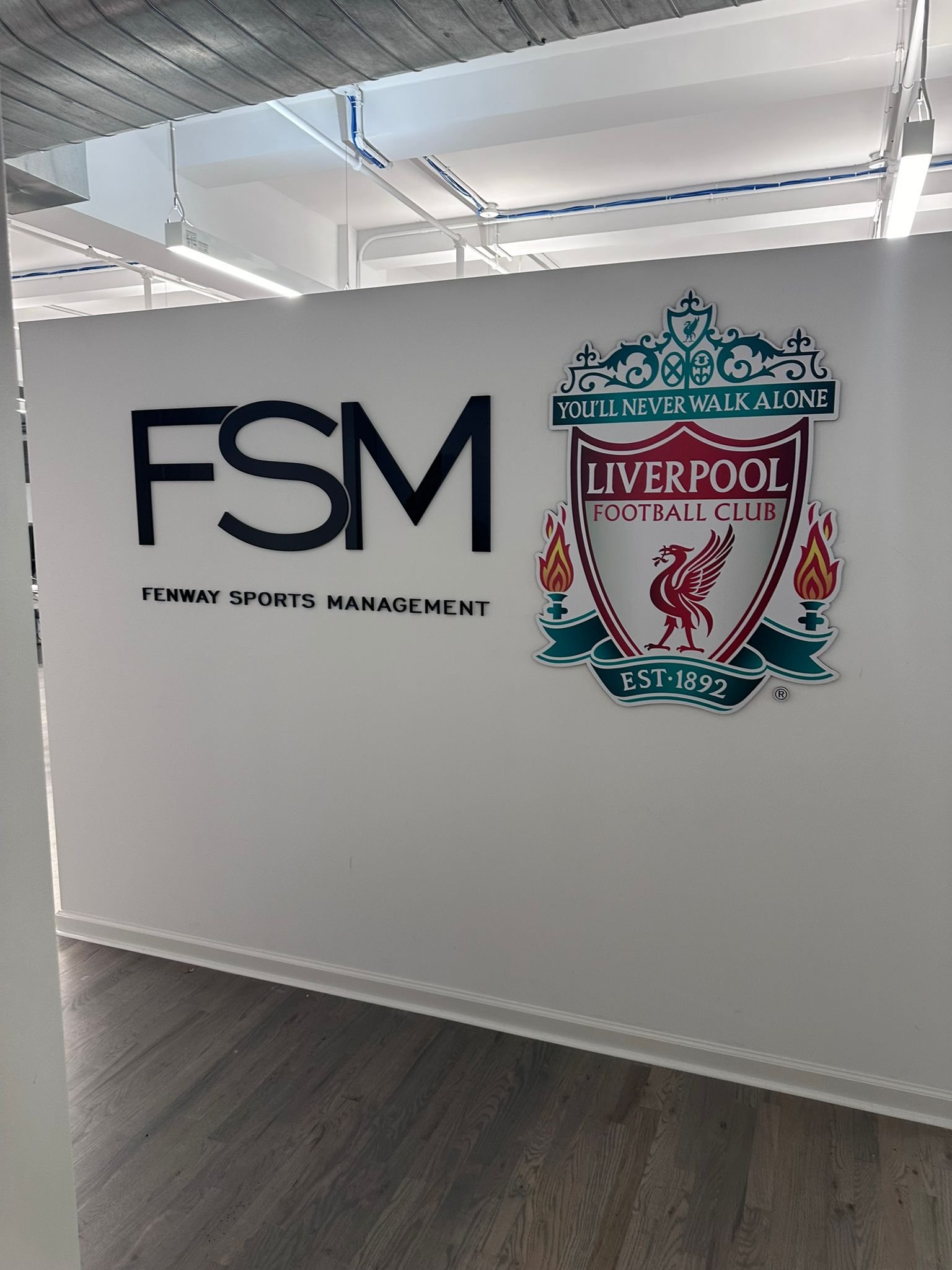 A wall with the letters fsm and liverpool on it