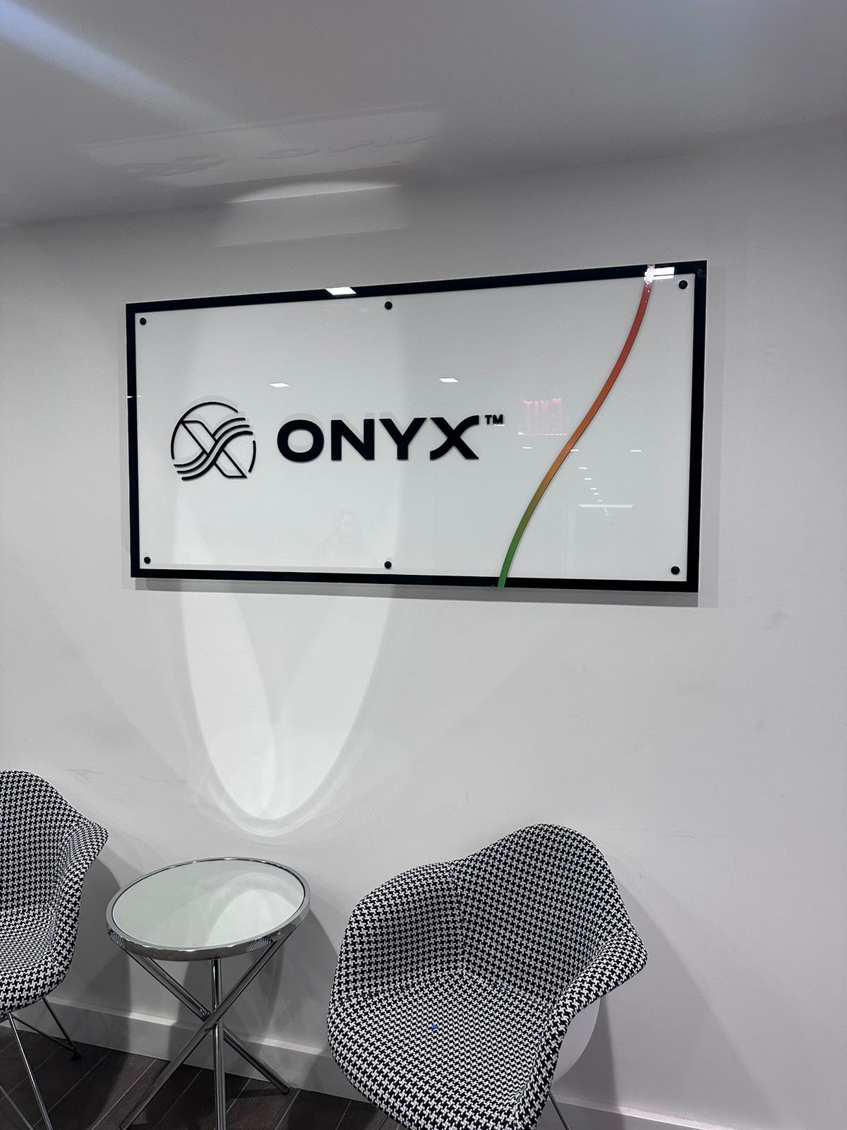 A white wall with a black frame and the logo of onyx.