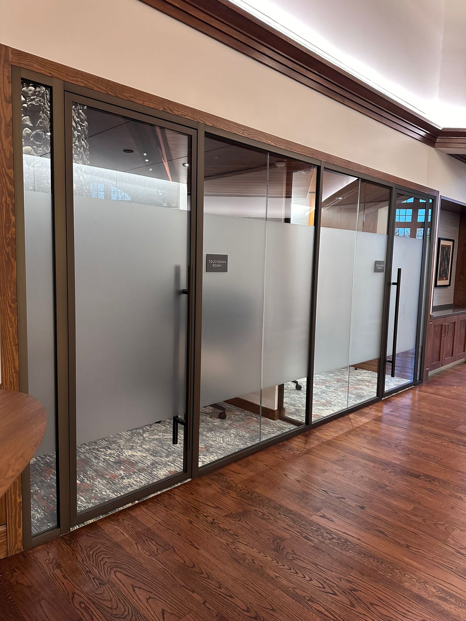 A room with glass doors and wood floors.