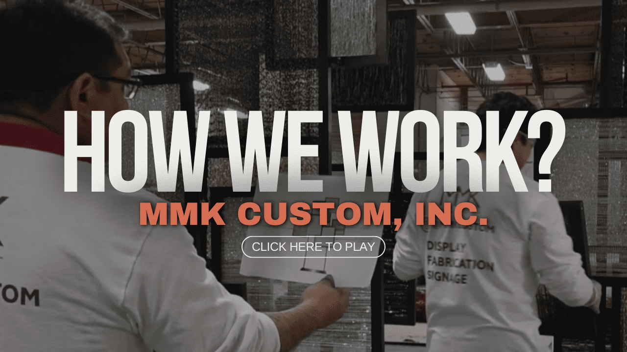 A picture of the back of two people holding papers.