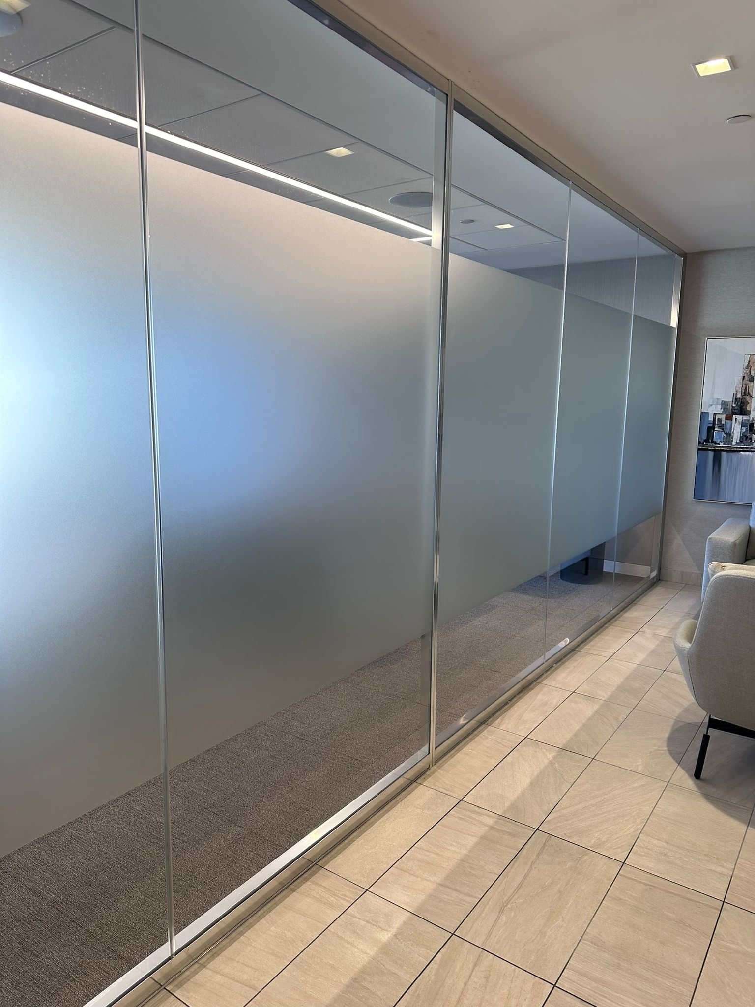 A room with glass walls and a couch in it.