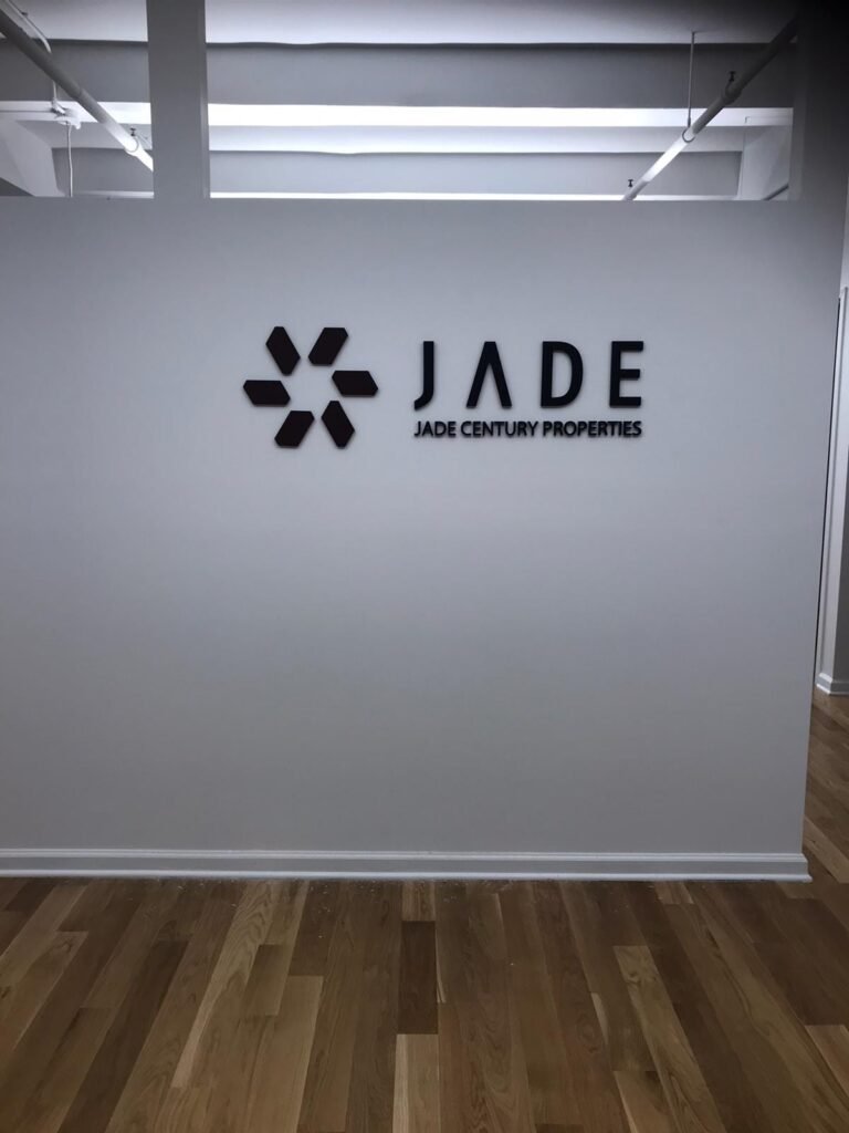Jade Century Properties logo on wall.